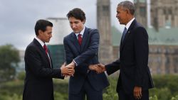 (L-R)Mexican President Enrique Pena Nieto, Canadian Prime Minister Justin Trudeau and US President Barack Obama pose for a group photo with Canada's Parliament Hill in the background during the North American Leaders Summit on June 29, 2016 in Ottawa, Ontario. / AFP / Chris Roussakis        (Photo credit should read CHRIS ROUSSAKIS/AFP/Getty Images)