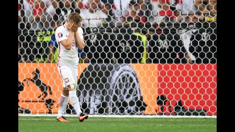 Poland's Jakub Blaszczykowski covers his face after his penalty was saved by Rui Patricio. It was the only miss of the shootout, which ended 5-3.