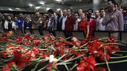 Family members, colleagues and friends of the victims of Tuesday blasts gather for a memorial ceremony at the Ataturk Airport in Istanbul, Thursday, June 30, 2016.  A senior Turkish official on Thursday identified the nationalities of Istanbul airport attackers after police carried out raids looking for Islamic State suspects. Tuesday's gunfire and suicide bombing attack at Ataturk Airport killed dozens and injured over 200. Turkish authorities have banned distribution of images relating to the Ataturk airport attack within Turkey.(AP Photo/Emrah Gurel)