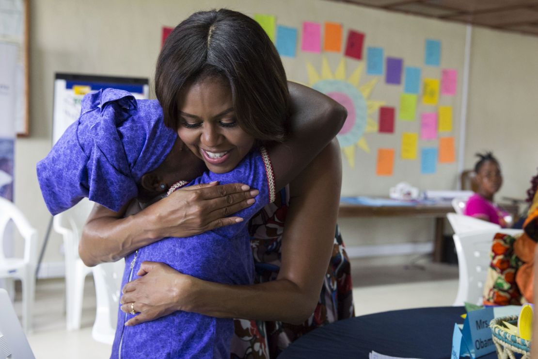 Michelle Obama hugs a student following a lesson plan about girls' leadership and self-esteem in support of the Let Girls Learn initiative, in Kakata, Liberia, June 27.