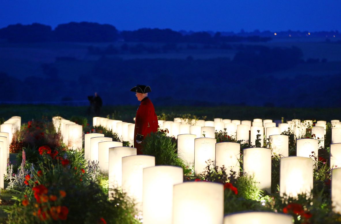 At dusk a man is seen among the military graves at the Thiepval Memorial.