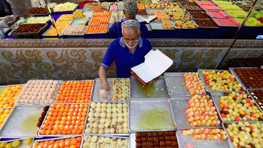DUBAI, UNITED ARAB EMIRATES - JULY 16: A man sells sweets ahead of Eid celebrations on July 16, 2015 in Dubai, United Arab Emirates. The Muslim holiday Eid marks the end of 30 days of dawn-to-sunset fasting during the holy month of Ramadan.  (Photo by Francois Nel/Getty Images)