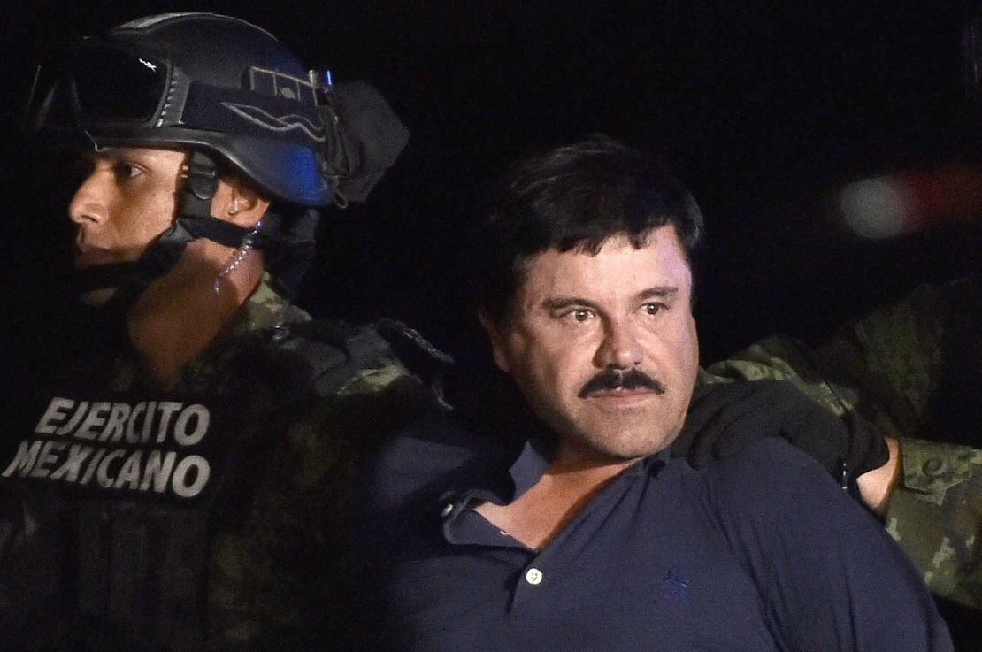 Guzman is escorted into a helicopter following his recapture in 2016.