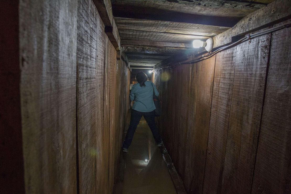 A journalist walks along a tunnel through which Guzman tried to escape.