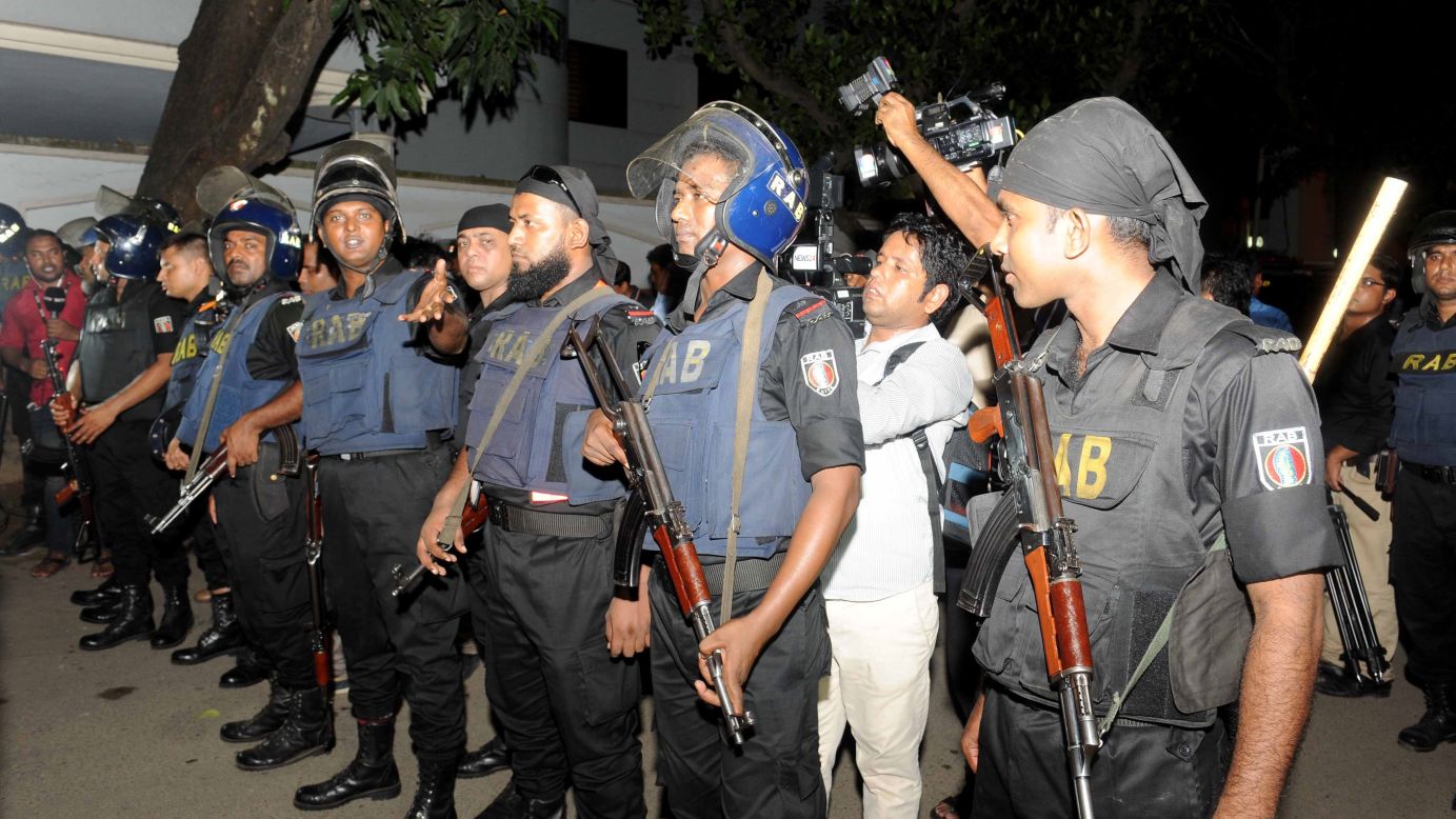 Police stand armed at the scene of the attack.