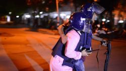 Bangladeshi police take cover near a restaurant that has been attacked by unidentified gunmen  in the early hours of July 2, 206 in Dhaka, Bangladesh. Gunmen have taken at least 20 foreigners hostage at a restaurant in the diplomatic area of Dhaka, the capital of Bangladesh.