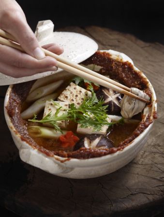 Oysters-on-the-riverbank hot pot. In this dish, rich earth-colored miso is smeared around the rim of the pot.  As the broth bubbles, the miso is drawn into the pot, little by little, flavoring and thickening the soup. 