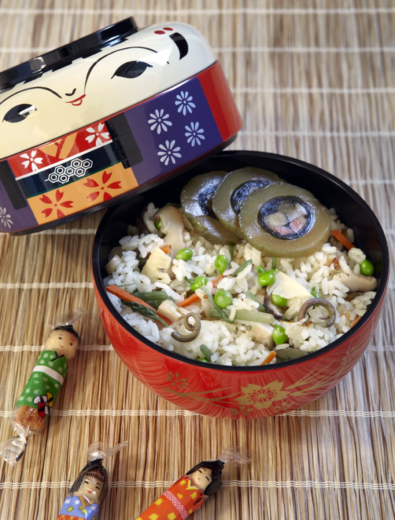 This fried tofu and mountain vegetable pilaf is served in a special kokeshi-shaped bento box. Kokeshi dolls are one of the most popular souvenirs in Tohoku.