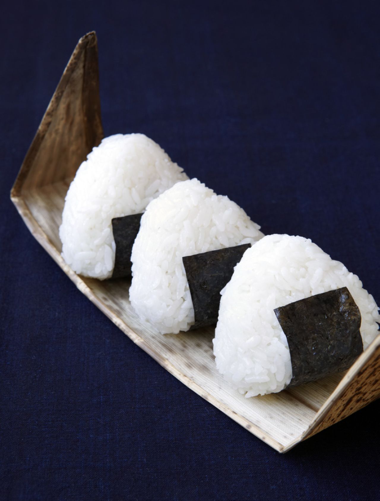 Salted, pressed rice sandwiches -- onigiri -- are easy to pack up, transport and eat, making them a substantial, satisfying finger food. 