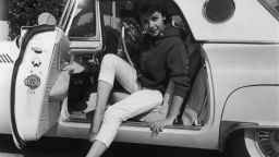 Portrait of American singer and actor Annette Funicello posing with her legs stretched out while preparing to exit a Ford Thunderbird, circa 1955.