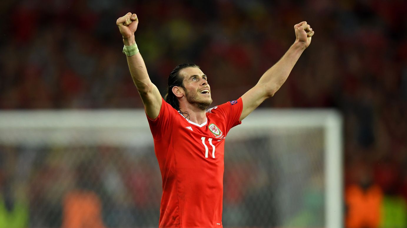 Welsh superstar Gareth Bale raises his arms in victory.