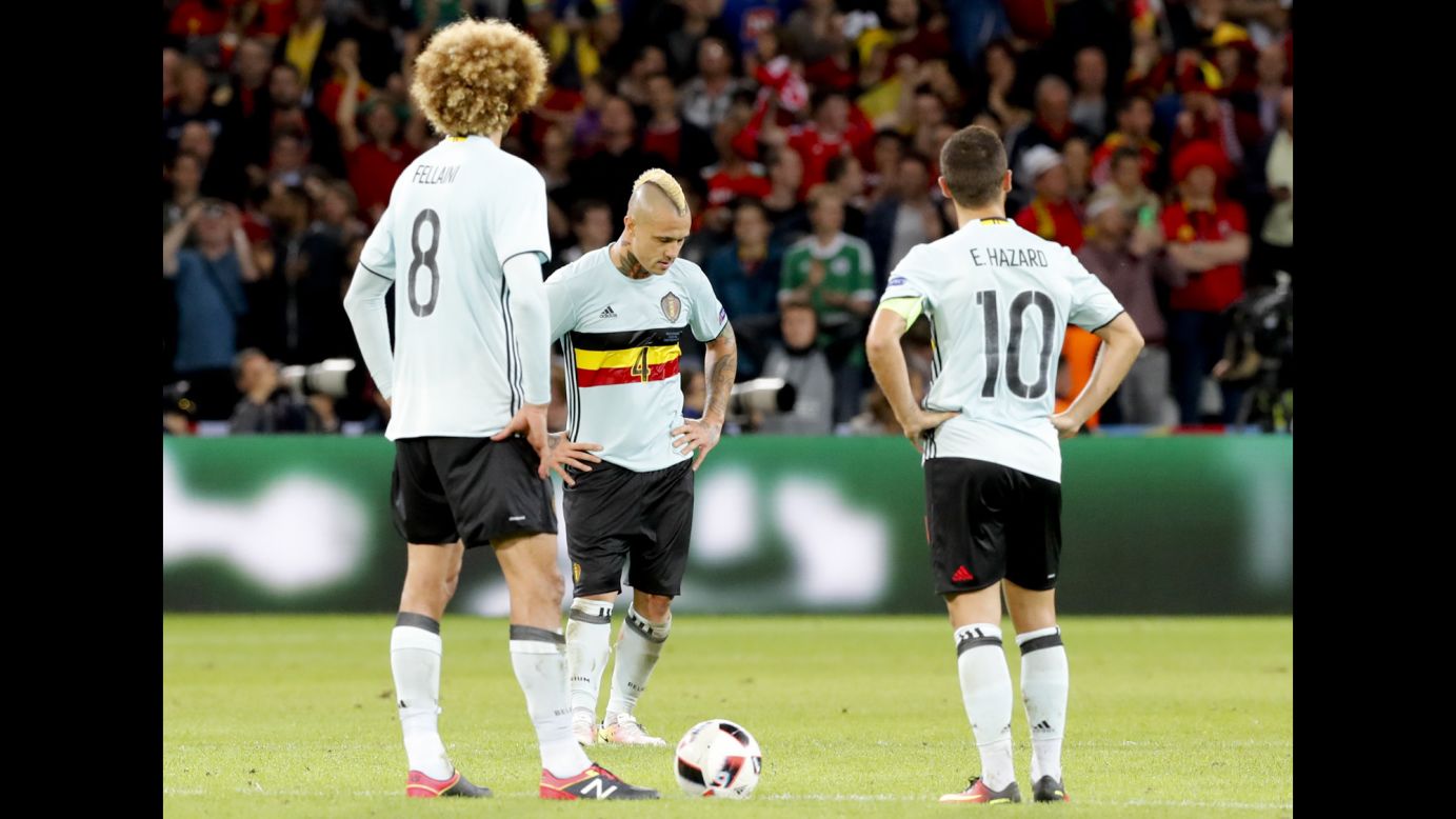 From left, Belgian players Marouane Fellaini, Radja Nainggolan and Eden Hazard react to Vokes' goal in the 85th minute.