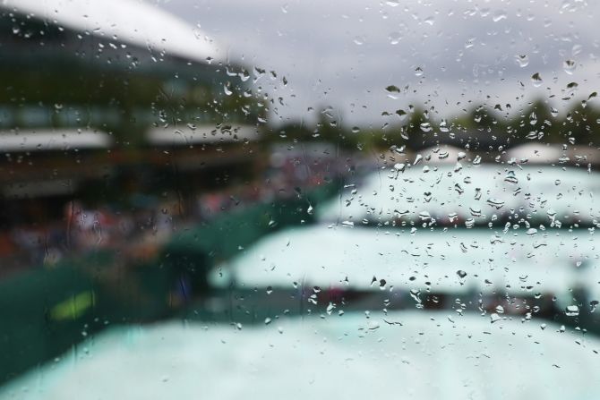 Del Potro and Wawrinka played under a roof on Centre Court ... because of yet more rain at SW19. 