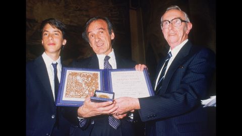 Author Elie Wiesel, center, with his son, Elisha, left, and Egil Aarvik, chairman of the Nobel committee, pose with the Nobel Prize in Oslo, Norway, on December 10, 1986.  