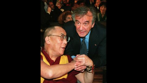 Nobel Peace Prize laureate Elie Wiesel, right, appears with the spiritual leader of Tibet, the Dalai Lama, during a ceremony for the 50th birthday of the Universal Declaration of Human Rights in Paris on December 7, 1998. 