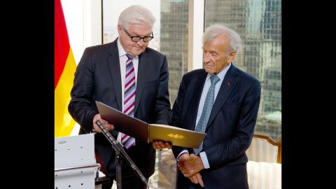 German Foreign Minister Frank-Walter Steinmeier, left, presents Elie Wiesel the German Federal Cross of Merit in New York on September 23, 2014.