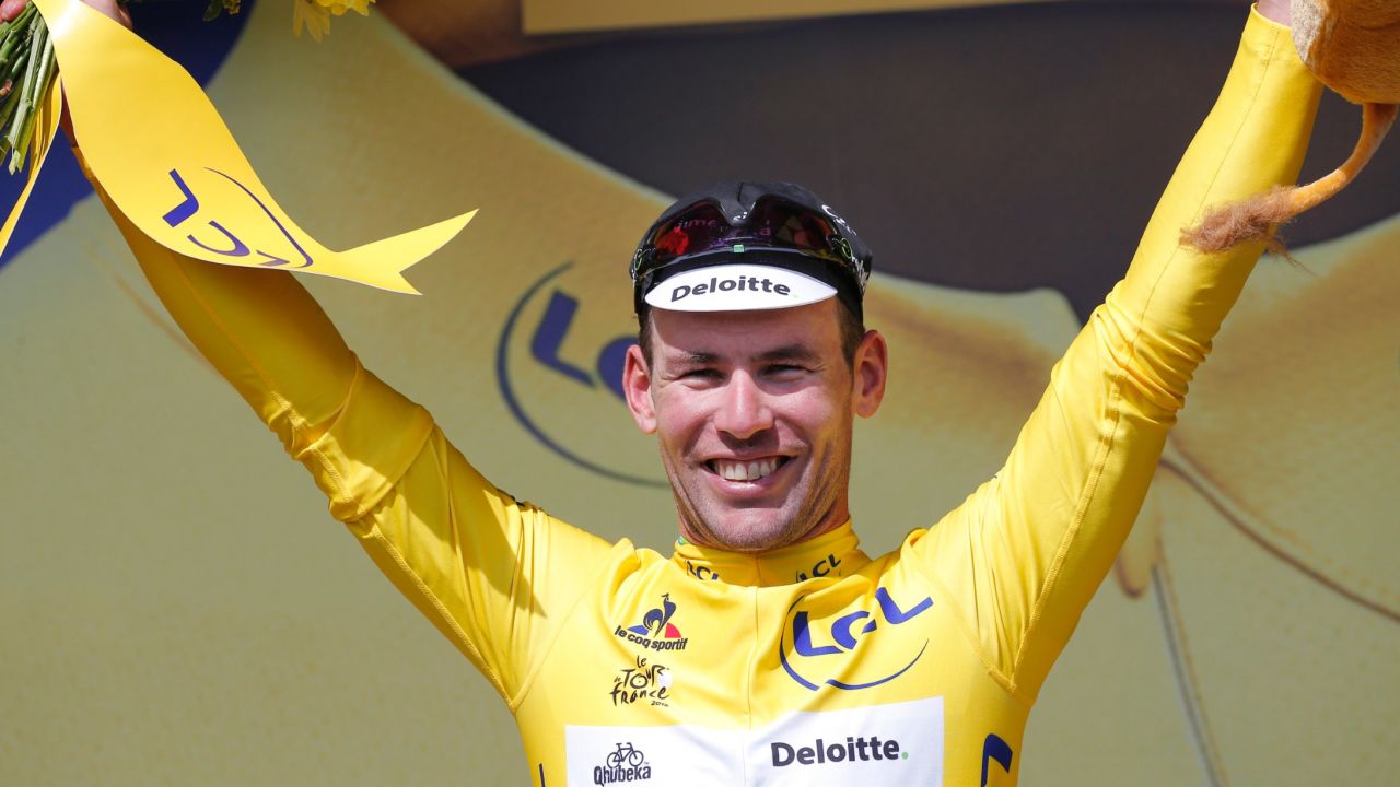 Britain's sprinter Mark Cavendish, wearing the overall leader's yellow jersey, celebrates on the podium after the first stage of the Tour de France cycling race over 188 kilometers (116.8 miles) with start in Mont-Saint-Michel and finish in Utah Beach, France, Saturday, July 2, 2016. (AP Photo/Christophe Ena)