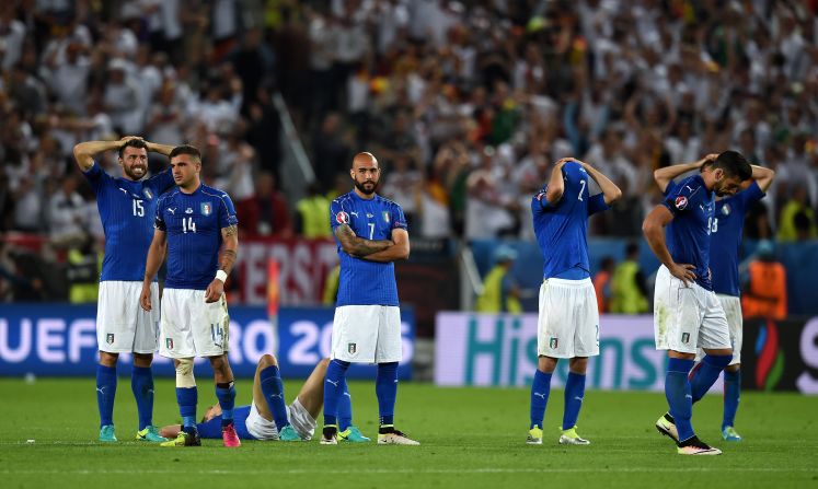 Italy players react after their defeat after the penalty shootout.