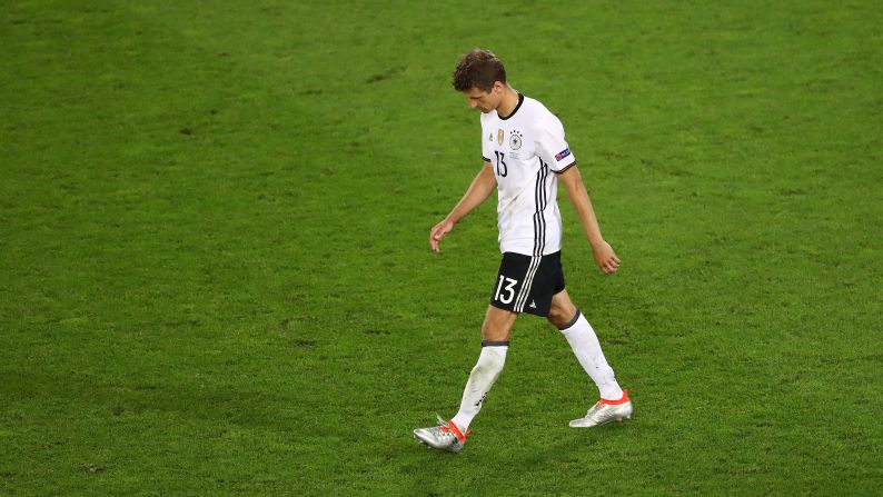 Thomas Mueller of Germany walks off after his penalty was saved by Italy's Gianluigi Buffon.