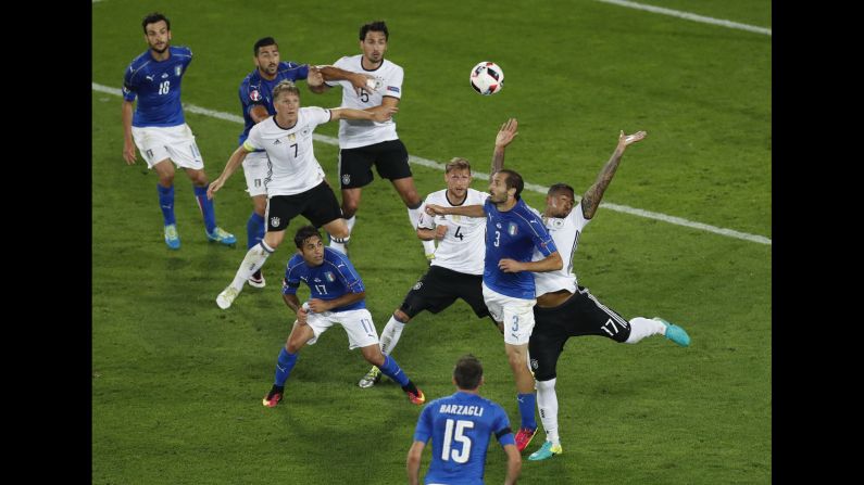 Italy's Giorgio Chiellini, right, is fouled by Germany's Jerome Boateng.
