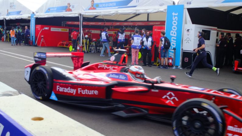 At the halfway point of the race, the pit lane comes alive as drivers rush in to change cars. 