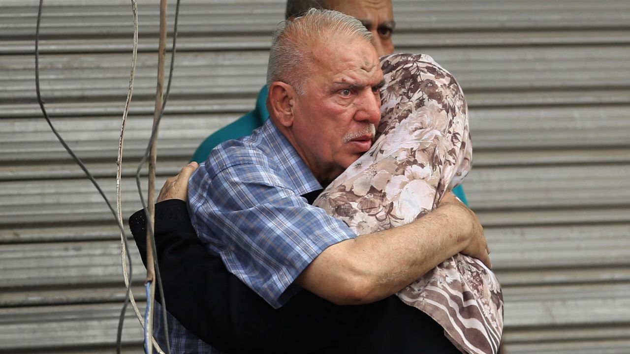 People hug near the site of the Karrada blast.