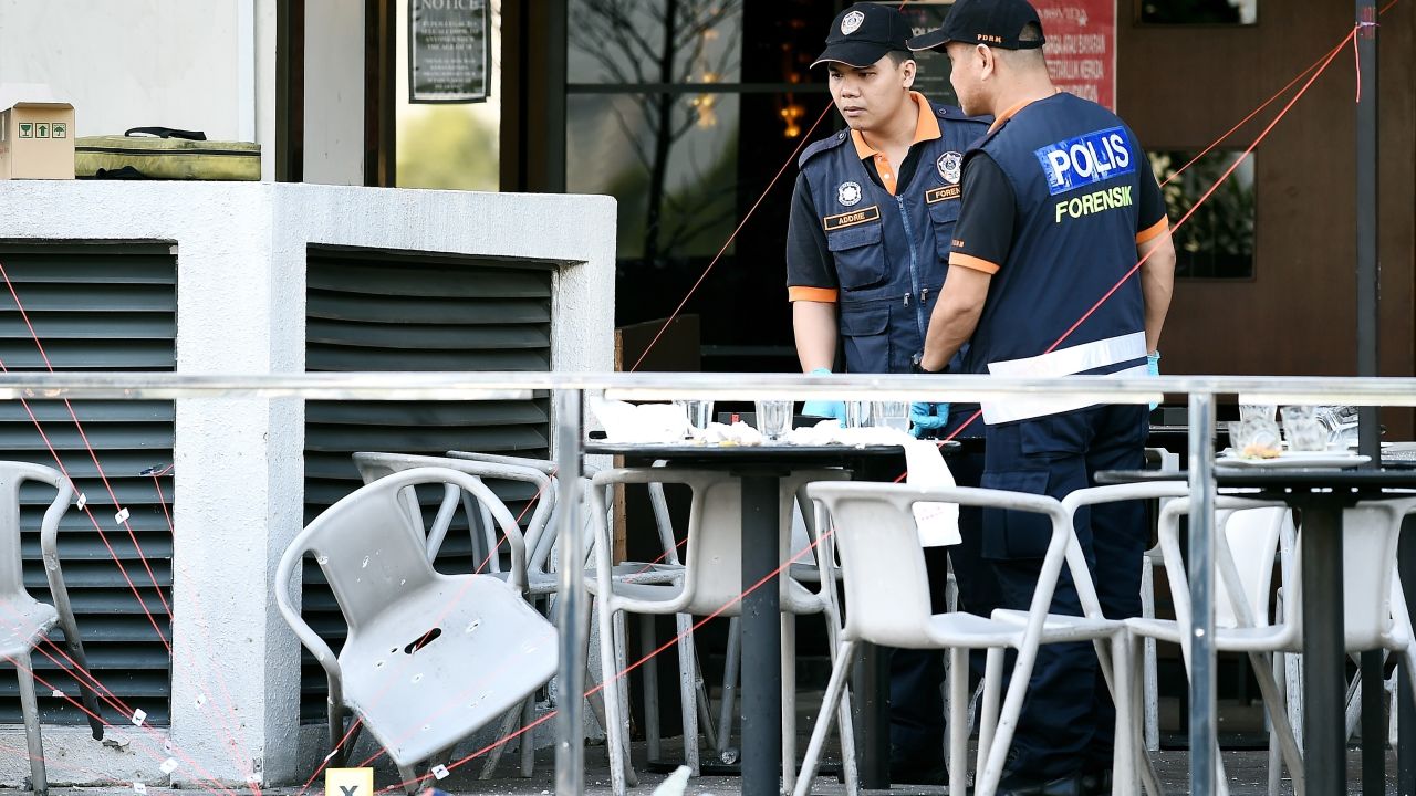 Malaysian forensic experts inspect the site of grenade attack at Movida.