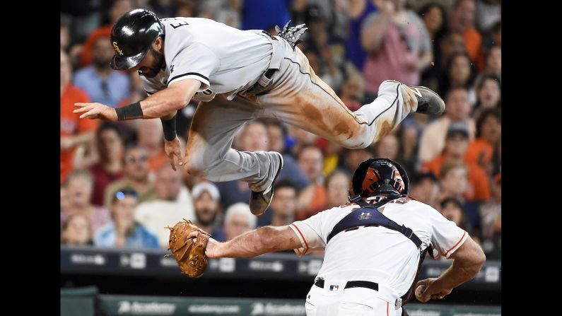Adam Eaton, outfielder for the Chicago White Sox, leaps over Houston catcher Evan Gattis on Saturday, July 2. He was tagged out on the play.