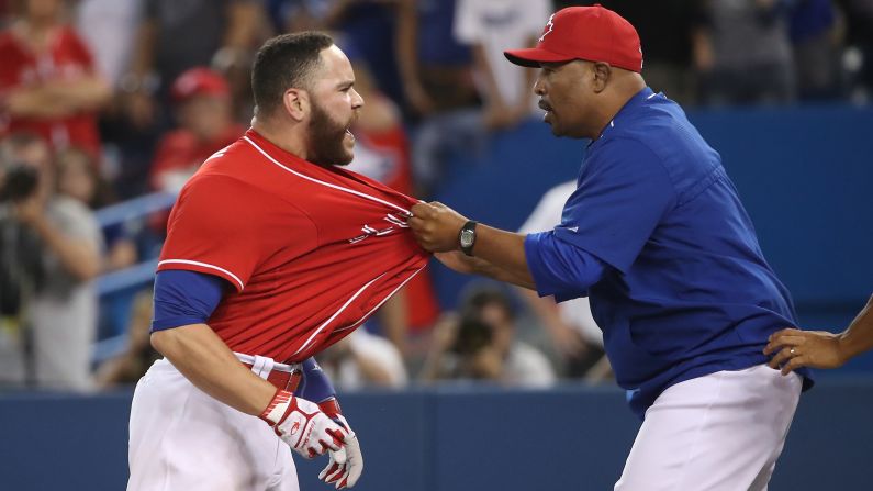 Toronto catcher Russell Martin is restrained by coach DeMarlo Hale after being ejected from a game on Friday, July 1. Martin was ejected for arguing a third called strike.