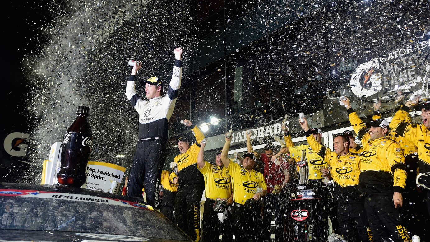 Brad Keselowski celebrates with his crew in Victory Lane after winning a Sprint Cup in Daytona Beach, Florida, on Saturday, July 2.
