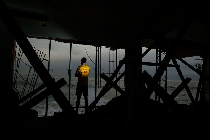 Coogee SLSC volunteer, Julien Vincent poses in the damaged Coogee Surf clubhouse. The first clubhouse -- a wooden shack -- was built in 1910. The current clubhouse suffered extensive damage during a violent storm that hit Sydney in June 2016. 