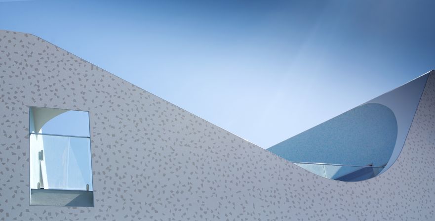 "The sweeping curves of the top parapet echo the curves of Bondi and the movement of the ocean. The external cladding are mosaic tiles that reflect day light, which is ever changing season to season," says Colquhoun. 