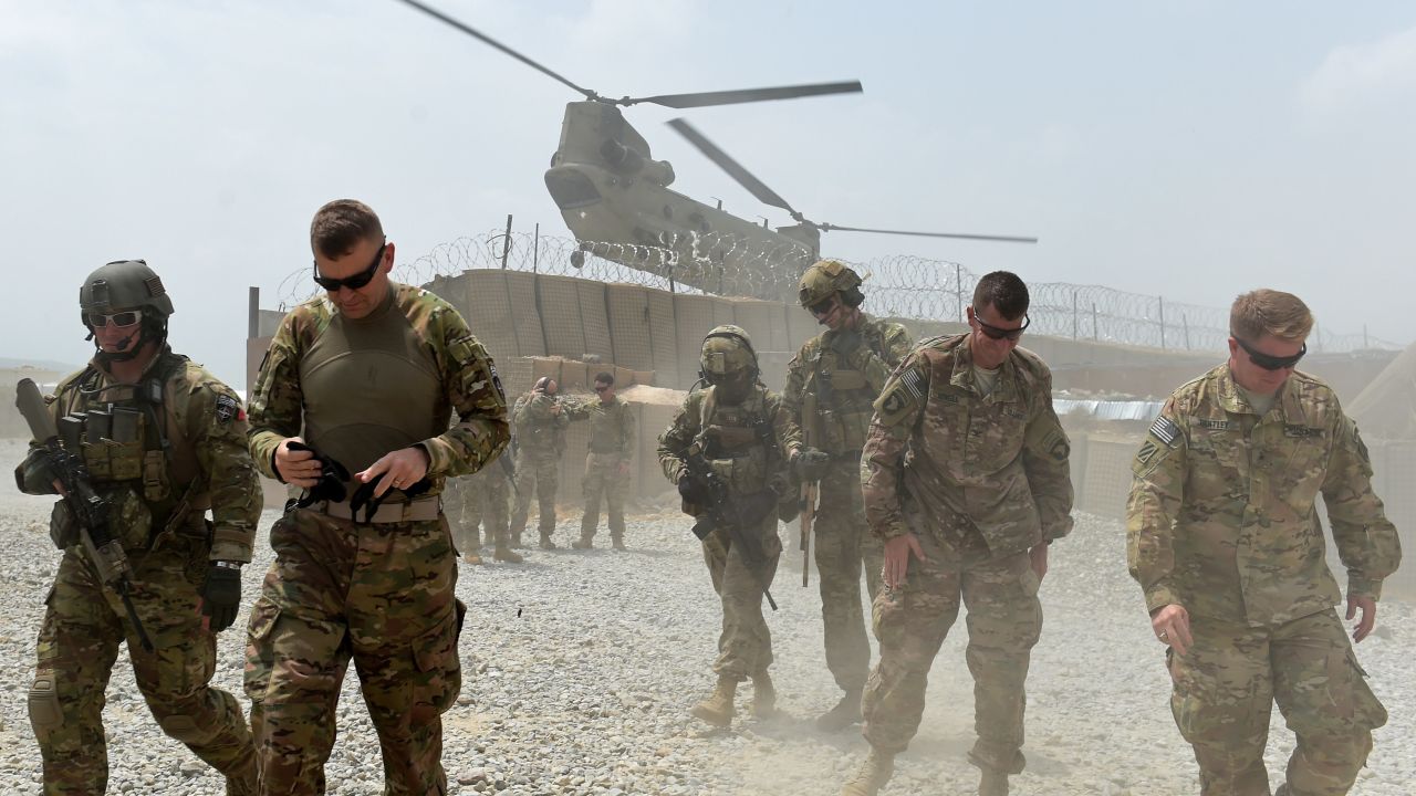 In this photograph taken on August 13, 2015, US army soldiers walk as a NATO helicopter flies overhead at coalition force Forward Operating Base (FOB) Connelly in the Khogyani district in the eastern province of Nangarhar. From his watchtower in insurgency-wracked eastern Afghanistan, US army Specialist Josh Whitten doesn't have much to say about his Afghan colleagues. "They don't come up here anymore, because they used to mess around with our stuff. "Welcome to Forward Operating Base Connelly, where US troops are providing training and tactical advice to the 201st Afghan army corps as they take on the Taliban on the battlefield.