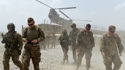 In this photograph taken on August 13, 2015, US army soldiers walk as a NATO helicopter flies overhead at coalition force Forward Operating Base (FOB) Connelly in the Khogyani district in the eastern province of Nangarhar. From his watchtower in insurgency-wracked eastern Afghanistan, US army Specialist Josh Whitten doesn't have much to say about his Afghan colleagues. "They don't come up here anymore, because they used to mess around with our stuff. "Welcome to Forward Operating Base Connelly, where US troops are providing training and tactical advice to the 201st Afghan army corps as they take on the Taliban on the battlefield. 