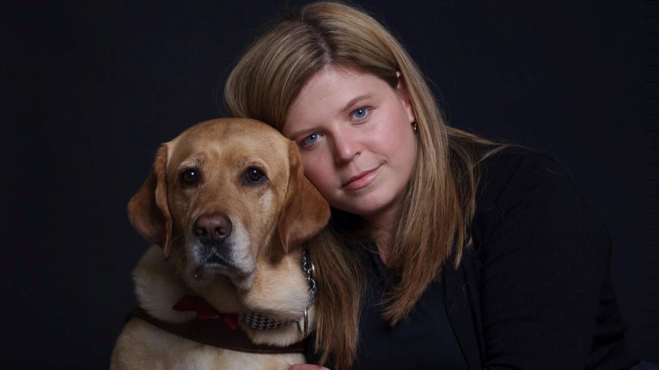 Trafficking survivor and advocate Margeaux Gray with her guide dog, Junebug.