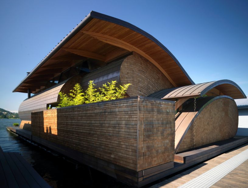 Made with a mix of western red cedar, Douglas Fir and copper, the Randall T. Fennell Residence sits gracefully on the Willamette River in Portland, Oregon. Curving rooftops mimic the ripples in the water below and create an eye-catching silhouette.<br />