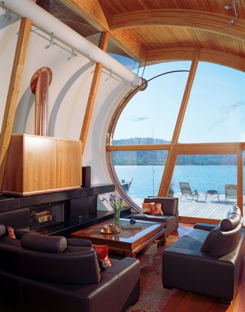 Surprisingly spacious inside, the 2,153-square-foot (200sqm) houseboat includes a loft-style master bedroom and an open living space. Drawn up like a sail, a clean white wall draws focus to the piece de resistance: a floor-to-ceiling glass window that looks onto the river.