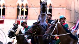 Jockeys of different Contrada ride their horses as they wait inside the "Mossa" (the starting line) during the historical Italian horse race of the Palio of Siena on July 02, 2016 in Siena. / AFP / GIUSEPPE CACACE        (Photo credit should read GIUSEPPE CACACE/AFP/Getty Images)