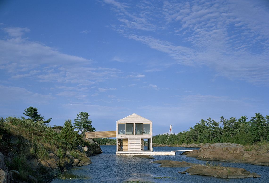 Inspired by the surroundings, MOS Architects designed Floating House Lake Huron with clean lines and a natural palette. Inside, bright white walls and enormous windows open up the ground floor's 1,000-square-foot space (92 square meters), while cedar rain screens on the facade offer both form and function.