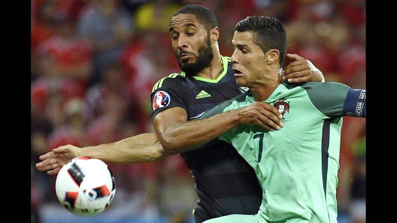 Welsh defender Ashley Williams fights off Ronaldo.