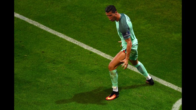 Ronaldo poses after scoring the first goal early in the second half. With the goal, Ronaldo tied Michel Platini for most goals in tournament history (nine).
