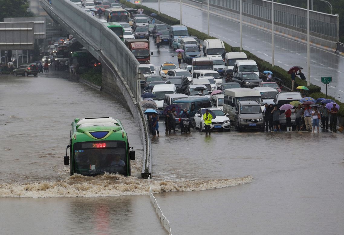 A bus struggles through flood waters on July 6, 2016. Floods and heavy rain paralyzed traffic in Wuhan, a megacity of 10 million on the Yangtze river. 