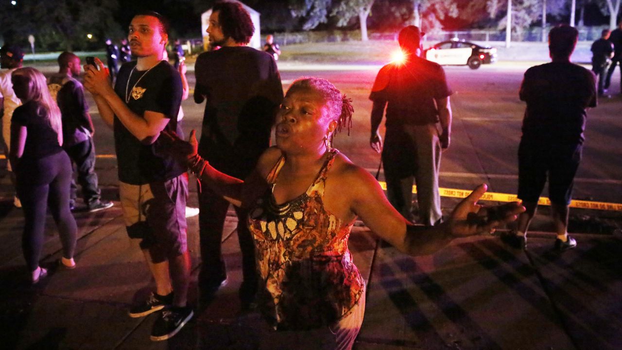 People gather at the scene of the shooting in Falcon Heights, Minnesota.