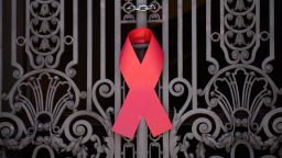 A red ribbon, the symbol of HIV/AIDS awareness, is put on a gate of the city council chamber during an NGO's campaign on the World AIDS Day in Rio de Janeiro, Brazil, on December 1, 2014.