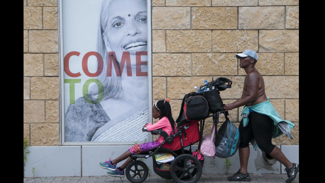 Pushing her daughter in a weighed-down stroller, Paulette Leaphart winds her way out of downtown Charlotte to continue her journey toward Washington. 