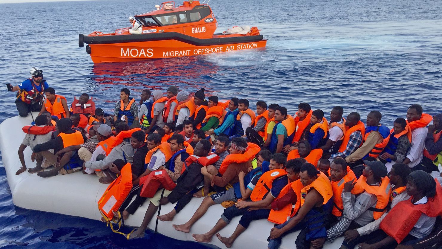 MOAS crews use a smaller boat to rescue migrants before bringing them on board the Topaz Responder.