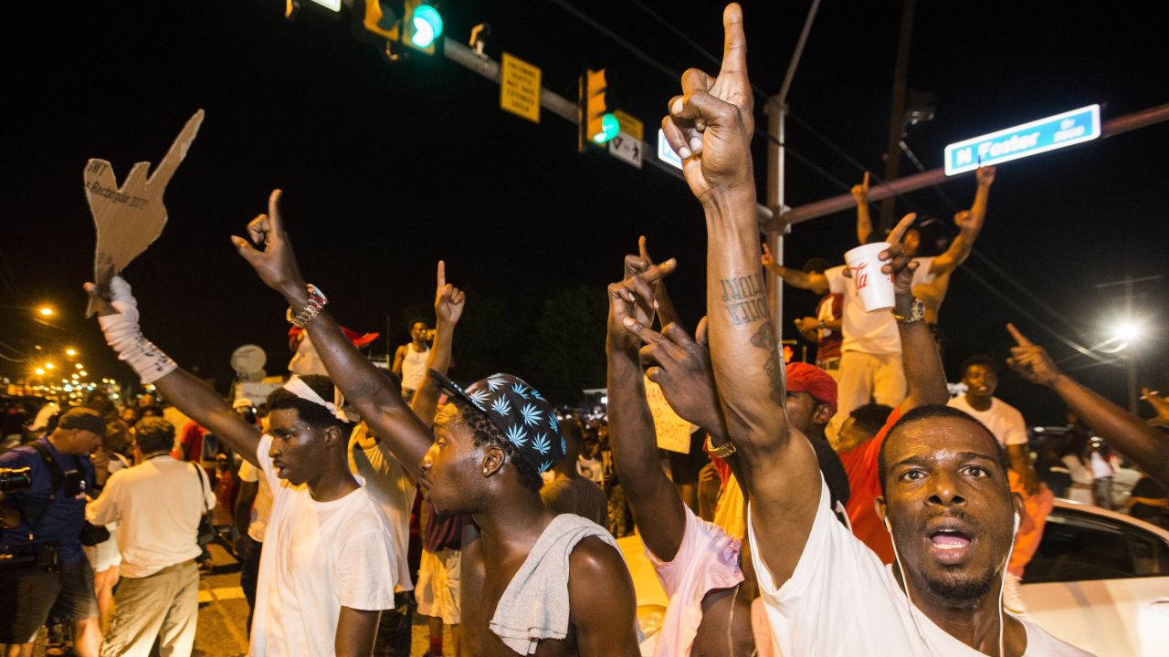 Protesters block traffic and dance on cars near the Triple S Food Mart in Baton Rouge.