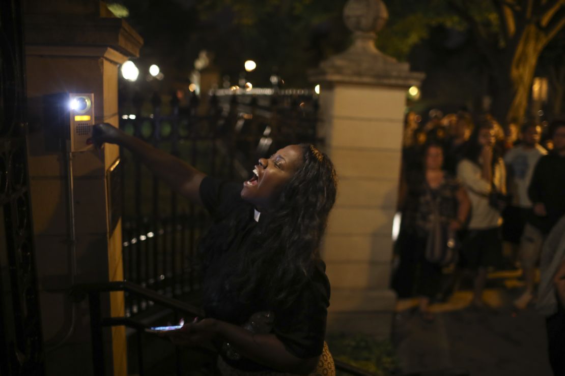 A woman rings the doorbell at the gate of the governor's mansion in St. Paul, Minnesota. 