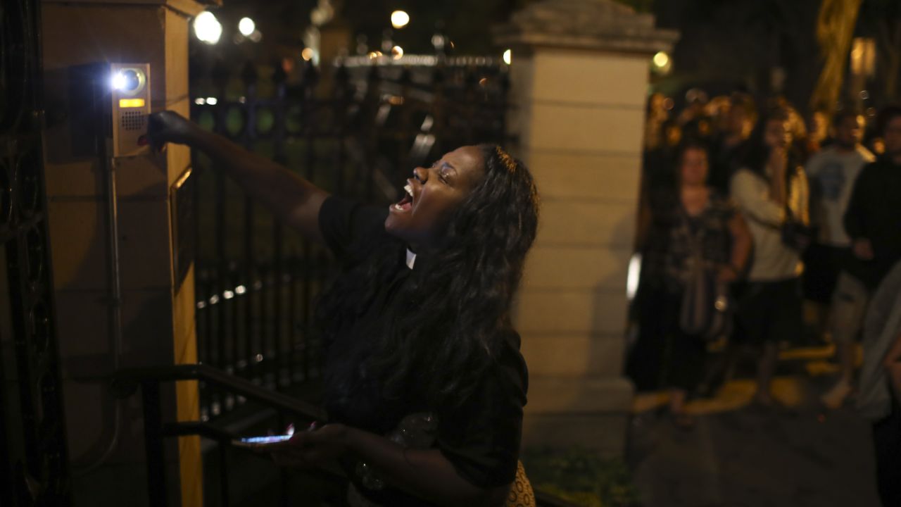 A woman rings the doorbell at the gate of the governor's mansion in St. Paul, Minnesota. 