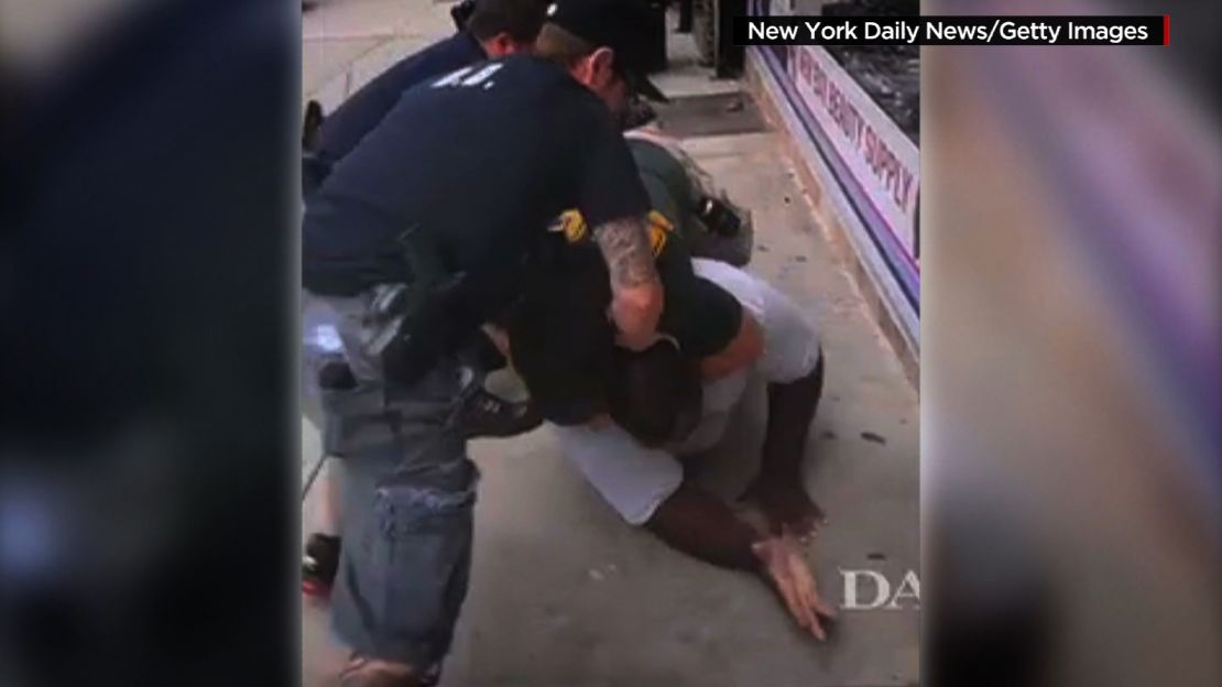 An NYPD officer puts Eric Garner in a prohibited chokehold.